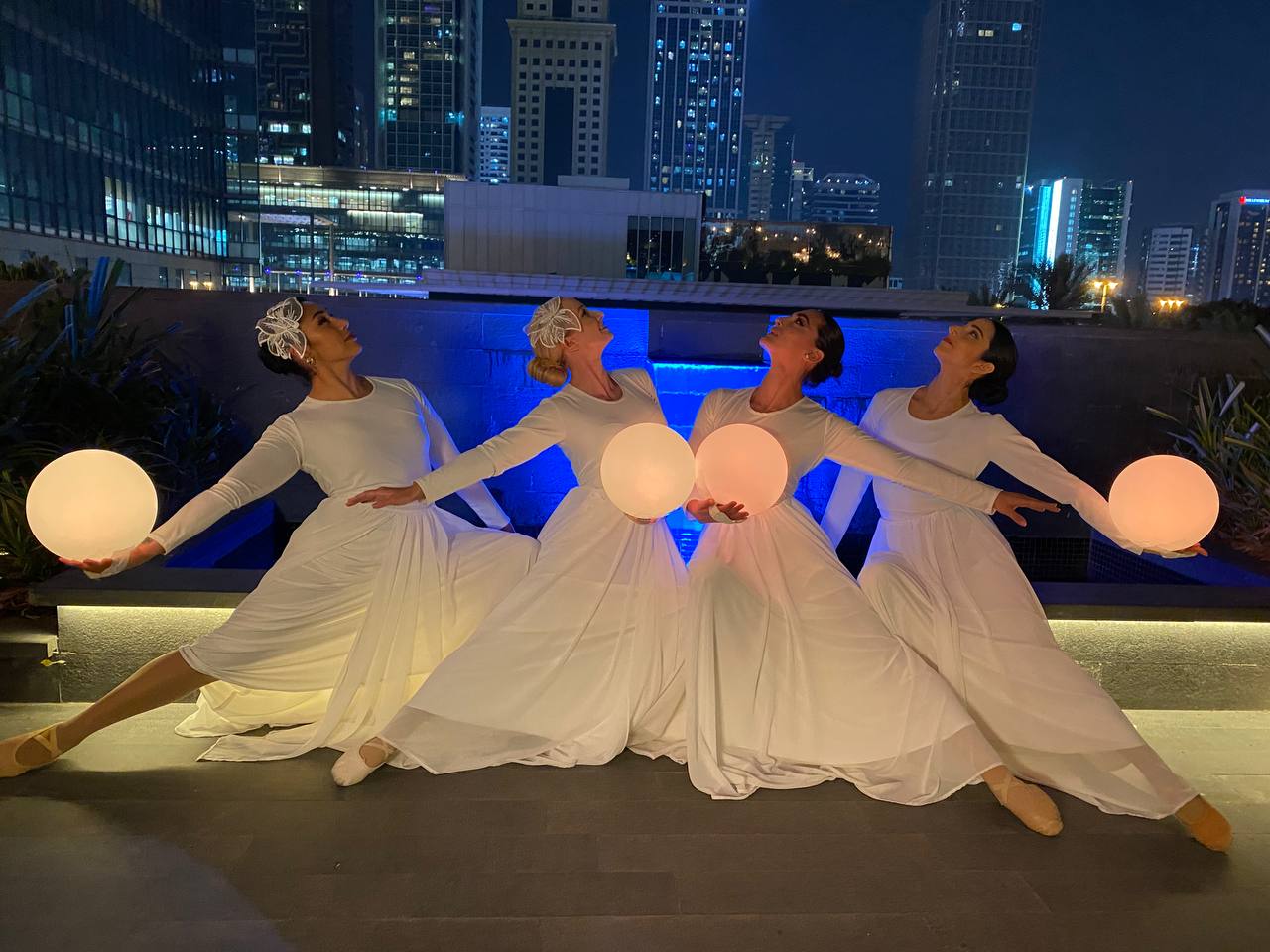 Flowing white dance performance at an outdoor event
