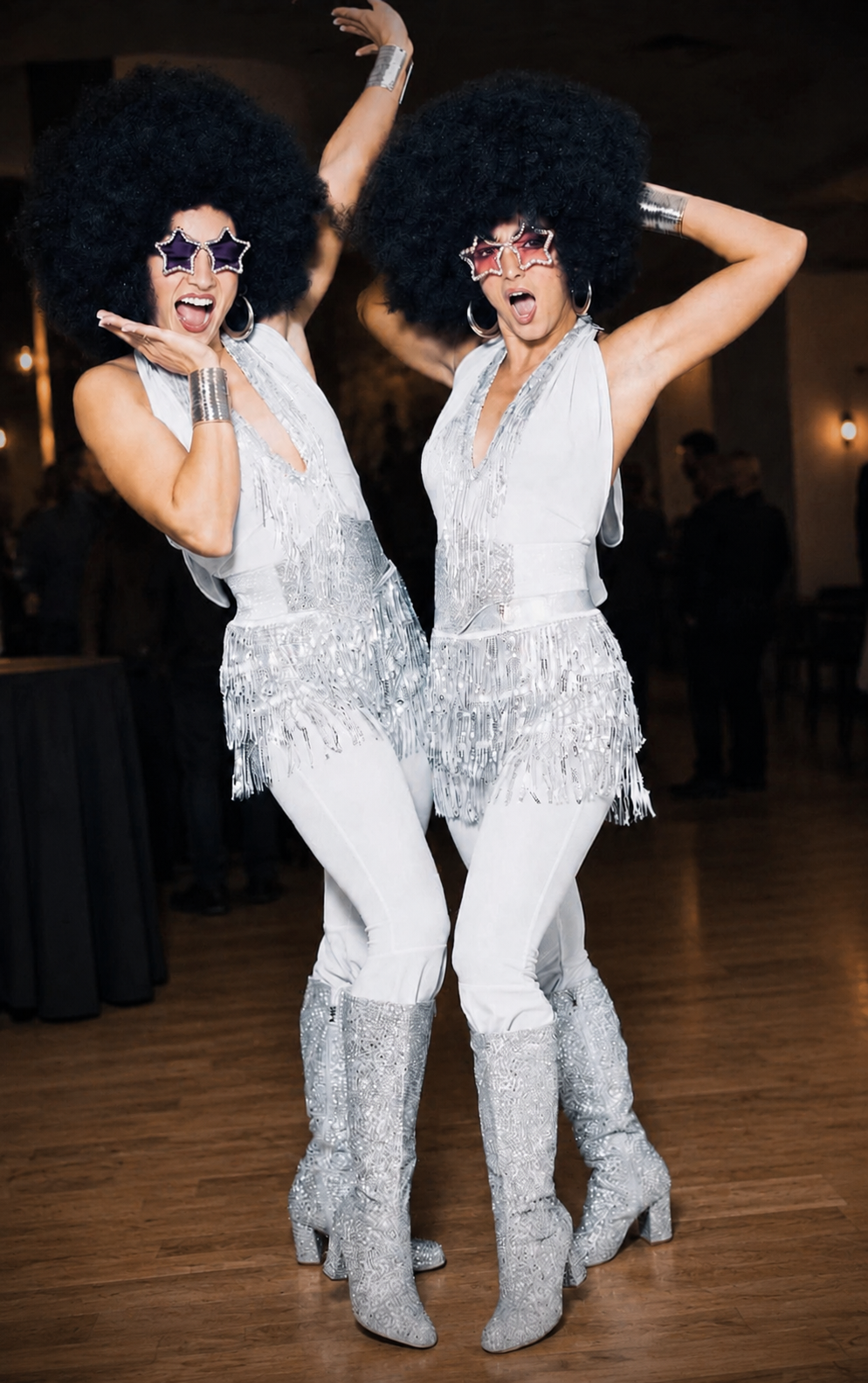 Silver disco duo entertaining guests on a wooden dance floor